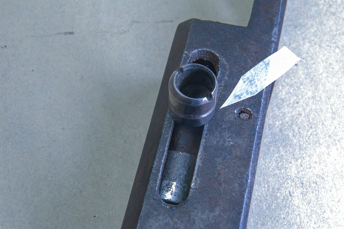 The cocking knob is wider than the slot for its threaded shank (see arrow) and can drag on the breechblock, causing failure to fire.